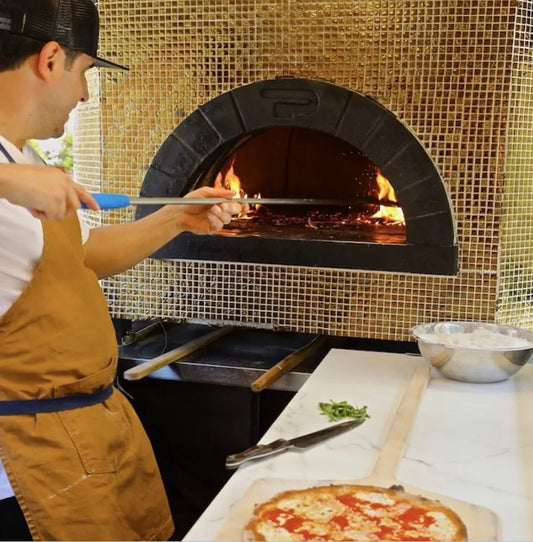 Pizzaiolo with a Pavesi Forni RPM 140/160 wood-fired oven