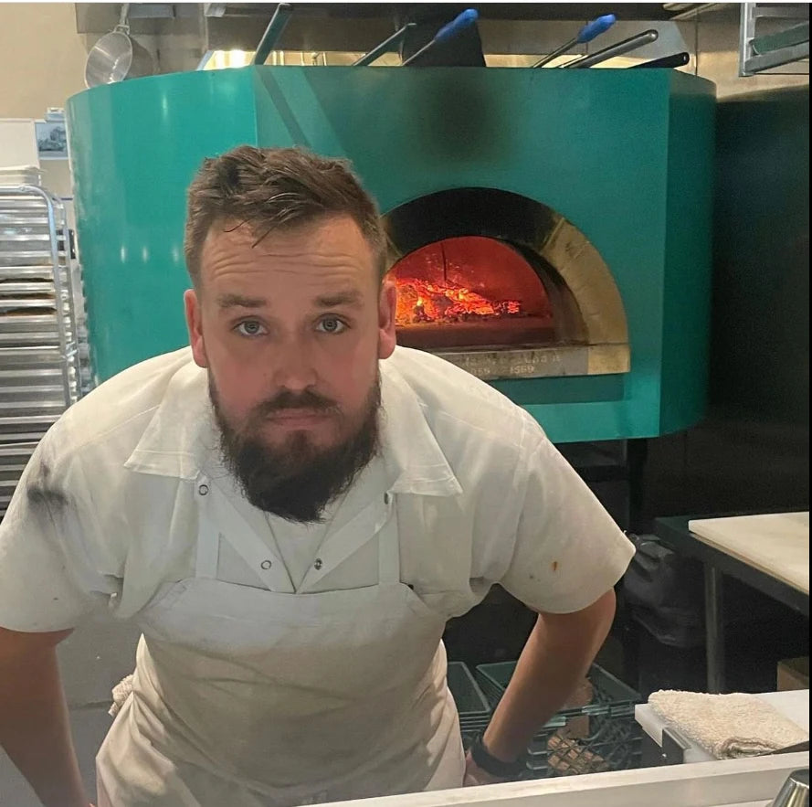 Pizzaiolo operating a customised Pavesi Forni RPM 140 wood-fired oven