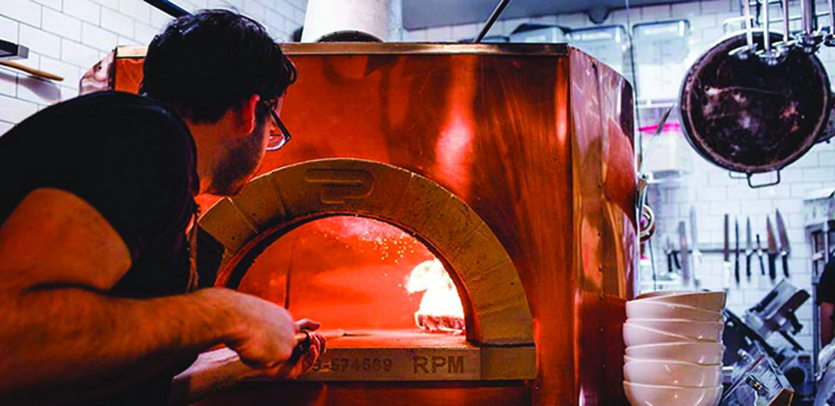 Pizzaiolo using a Pavesi Forni RPM 140 oven in Brooklyn