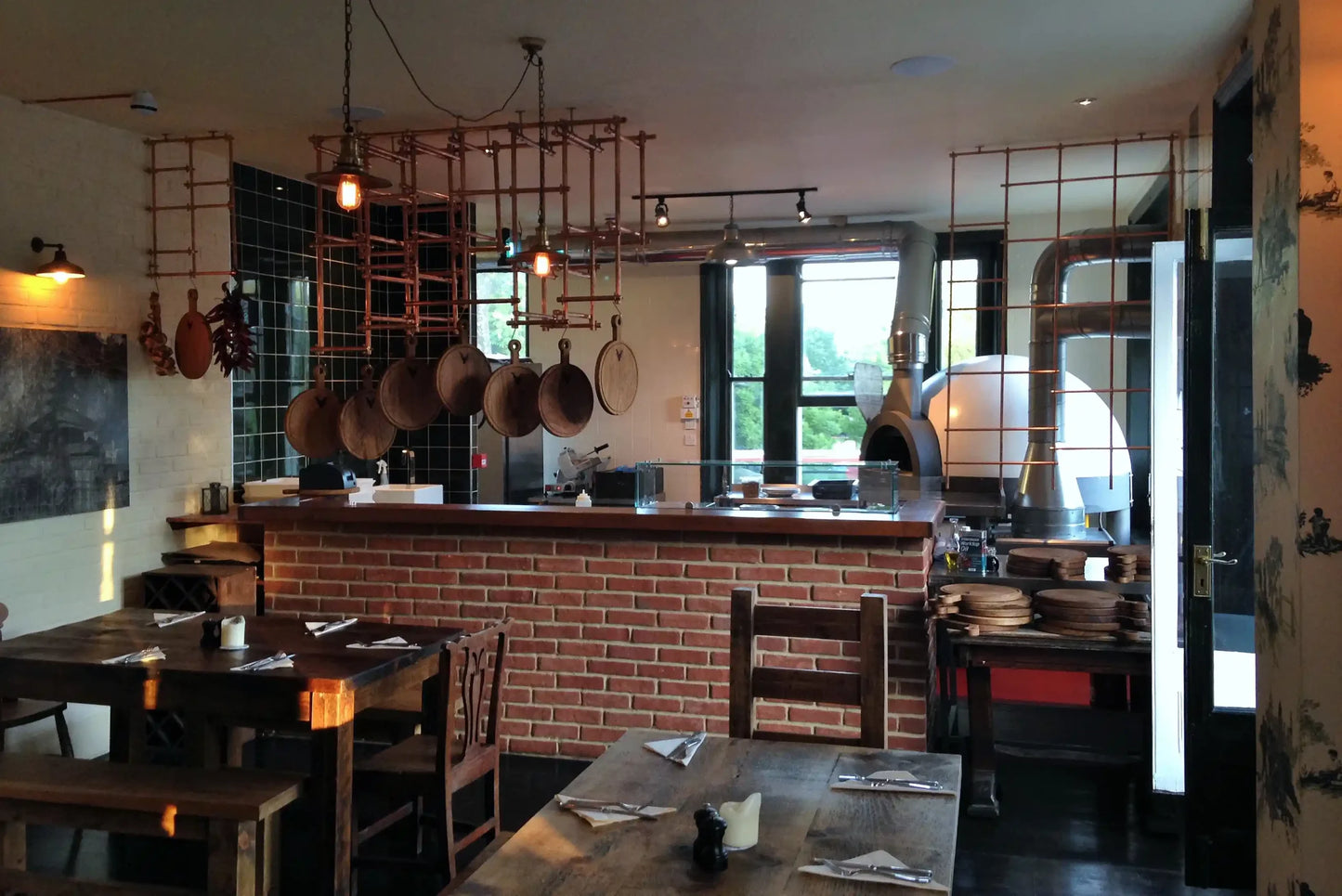 Pavesi Forni JOY 110 TW wood-fired rotating pizza oven installed in a restaurant