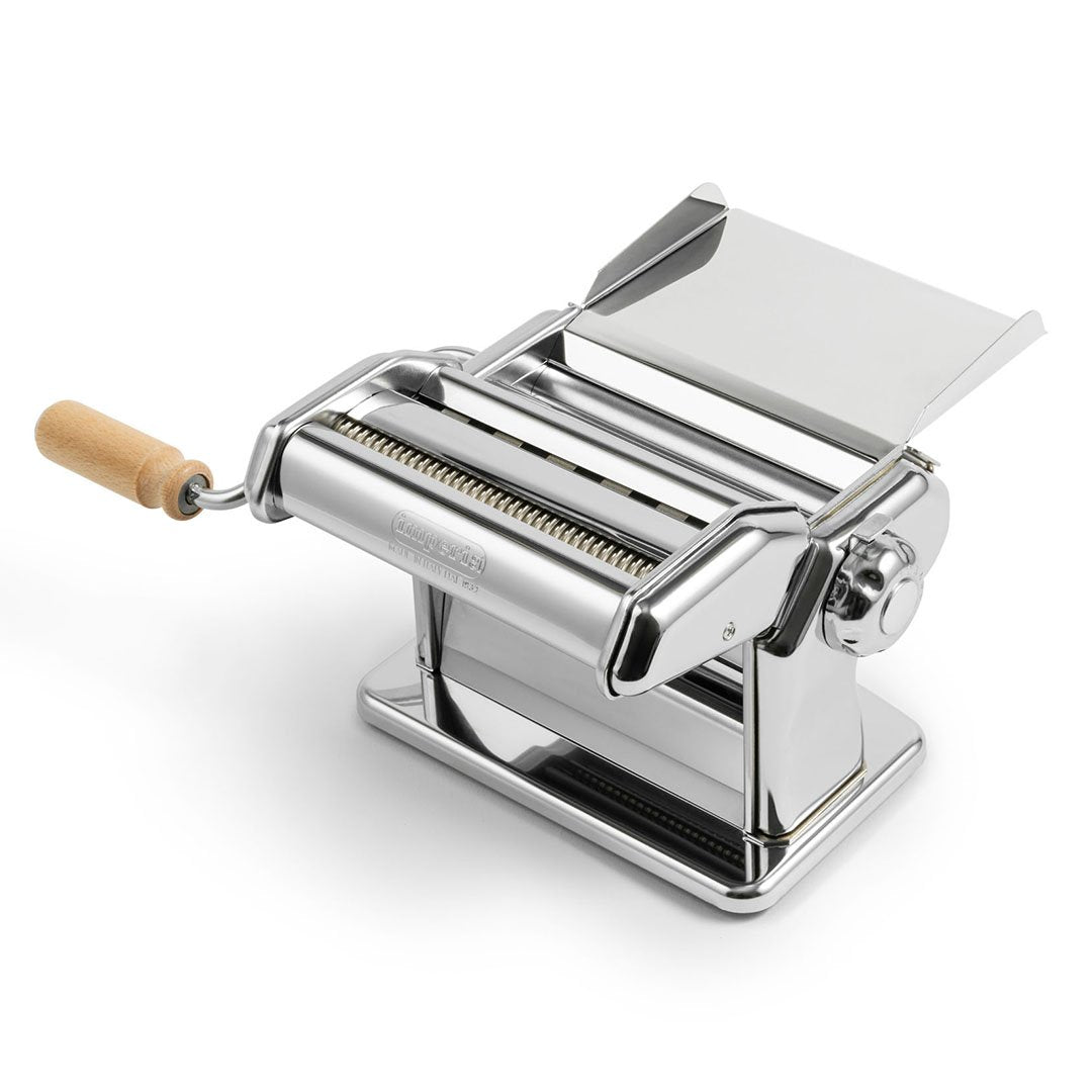 Imperia iPasta chrome manual pasta machine rolling a sheet of fresh pasta dough