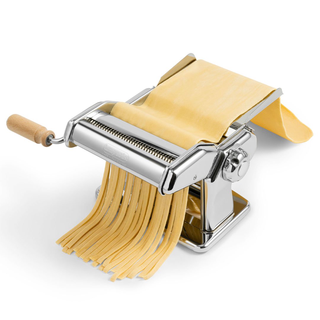 Imperia iPasta chrome manual pasta machine, detail view with fresh pasta sheet and cut tagliatelle
