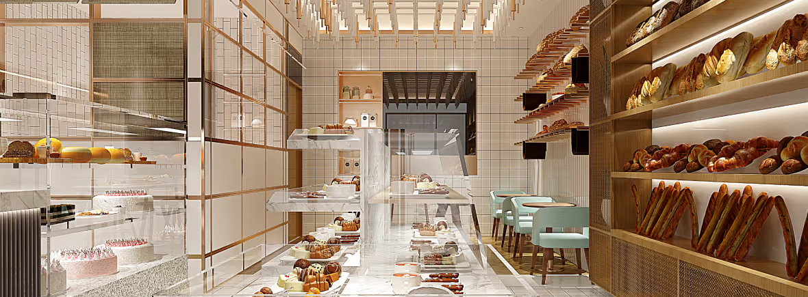 Modern bakery interior with marble counter and wooden shelves.